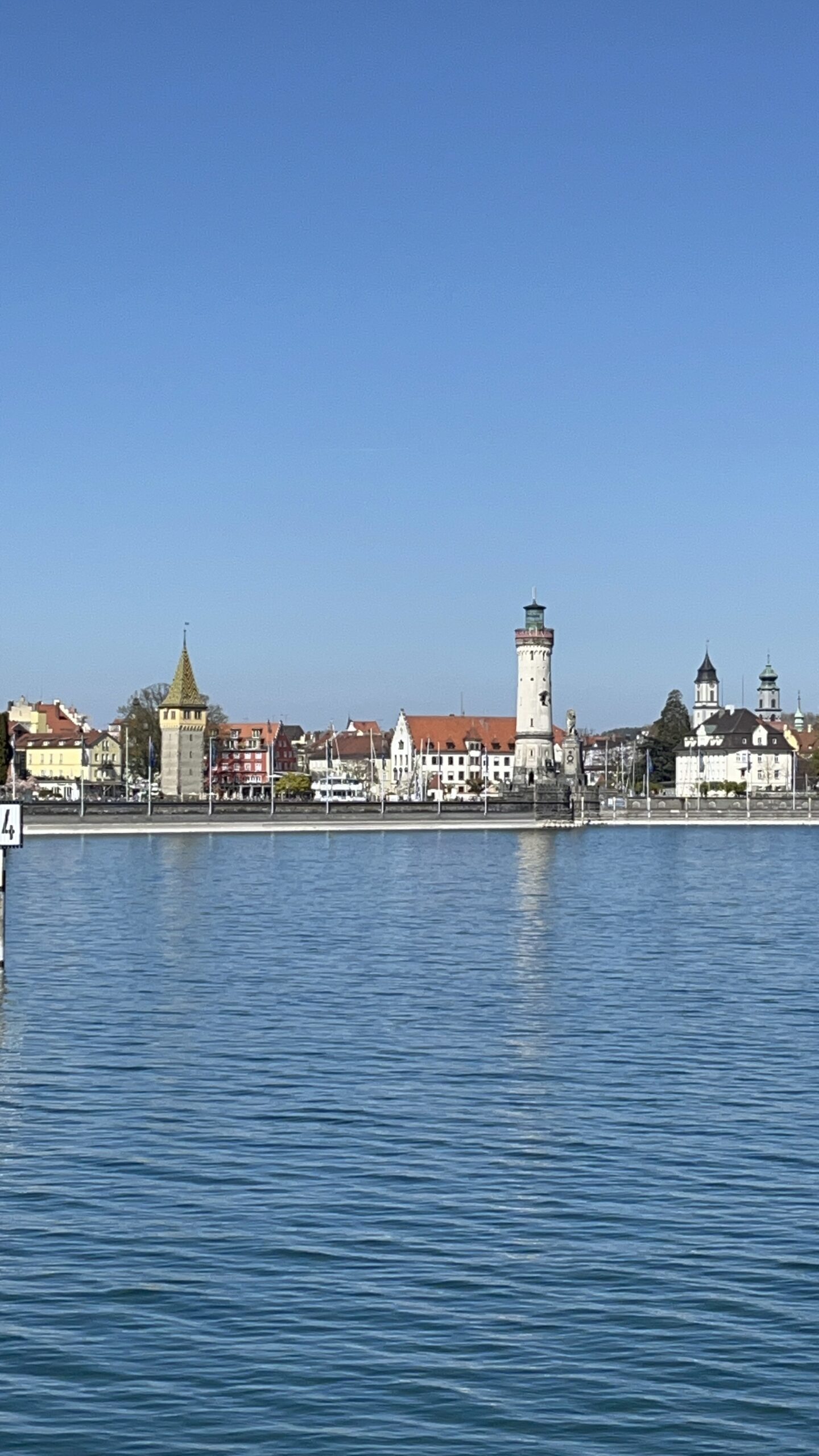 Puerto de Lindau con el faro blanco y el León de Baviera