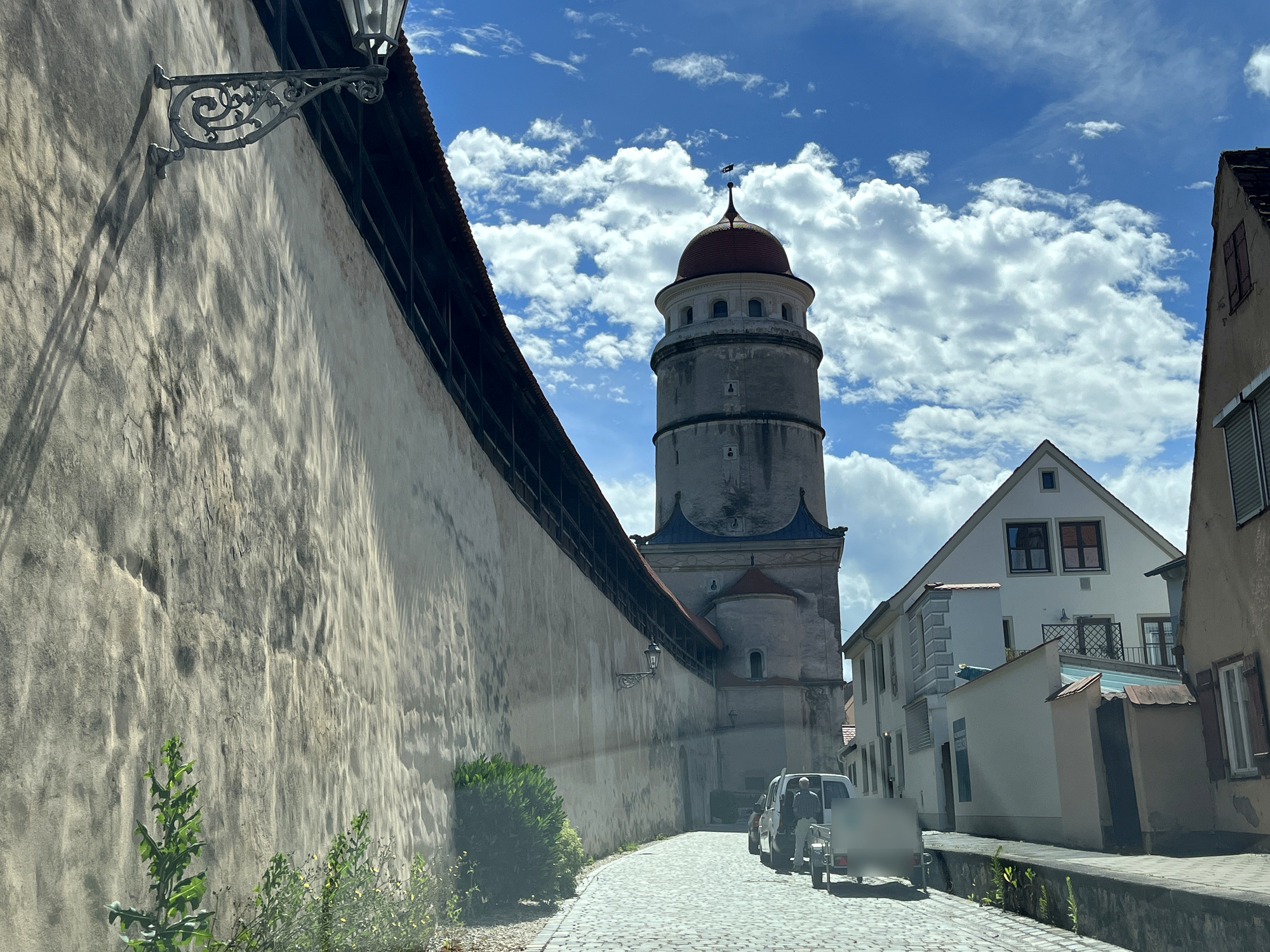 Muralha coberta de Nördlingen com o caminho de ronda de madeira e uma torre de portão ao fundo