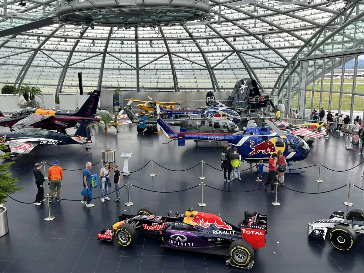 Aeronaves e carros de competição sob a cobertura de vidro do Hangar-7 em Salzburg