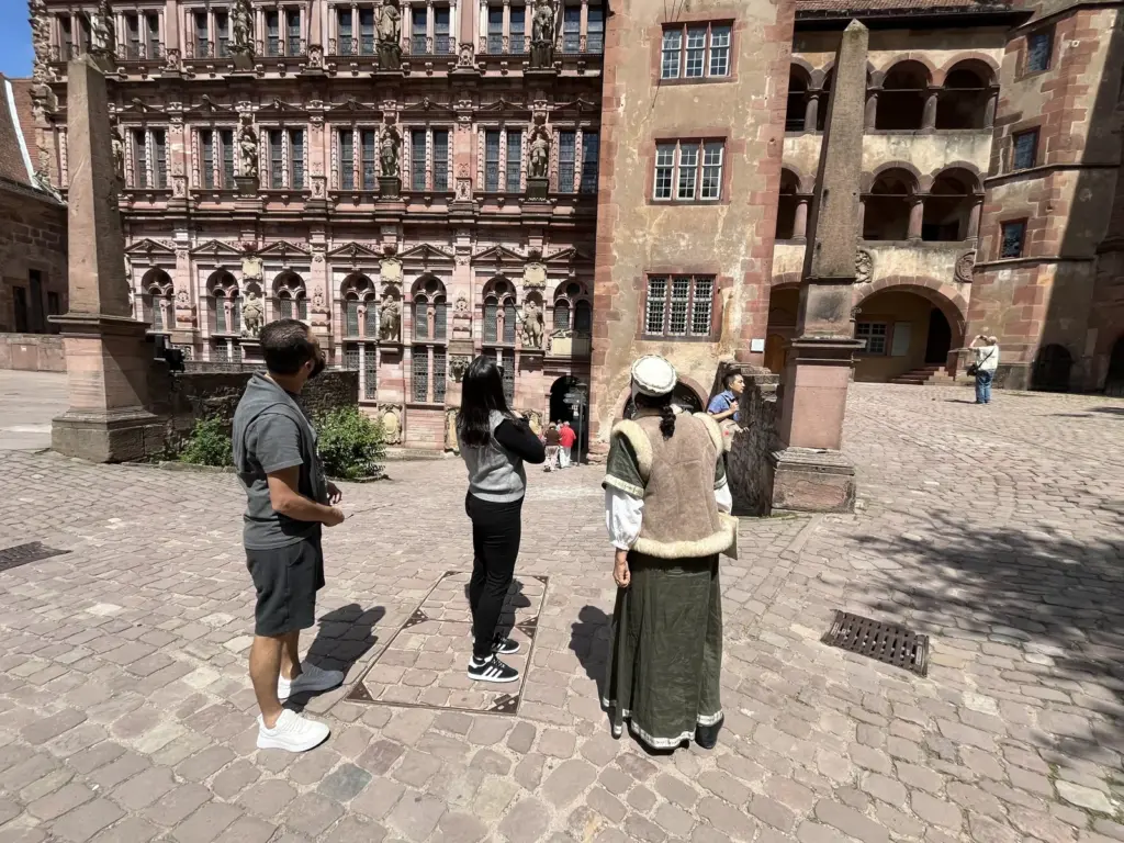 Visitantes diante da fachada esculpida do Friedrichsbau no Castelo de Heidelberg