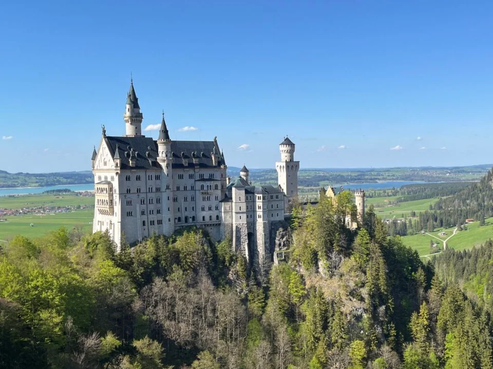 Castelo de Neuschwanstein entre montanhas e campos na Baviera